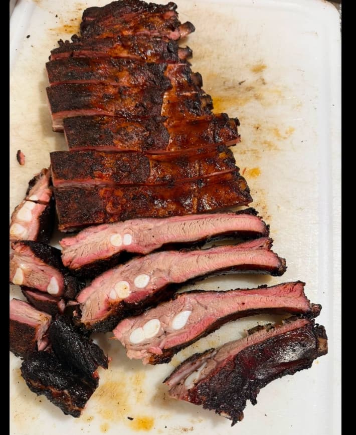 Smoked ribs resting on a board